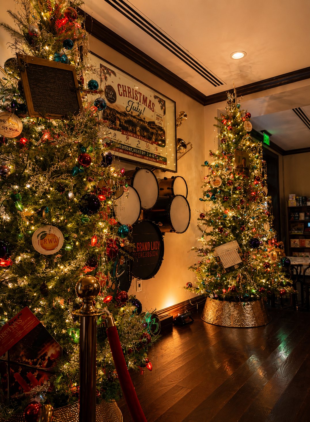 Two Christmas trees flanking a doorway in a decorated venue, styled by Light the Lights