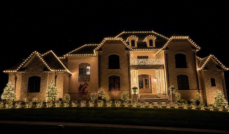Grand brick home with roofline holiday lighting, Valrico FL